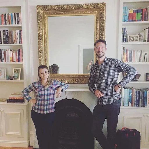 Professional picture hanging service in a Melbourne heritage home with large gold-framed mirror installed above fireplace by expert installers